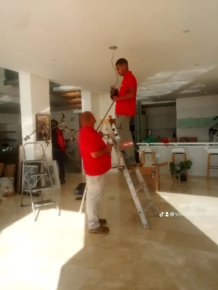 Abacas electricians installing ceiling light fixture in Cape Town home