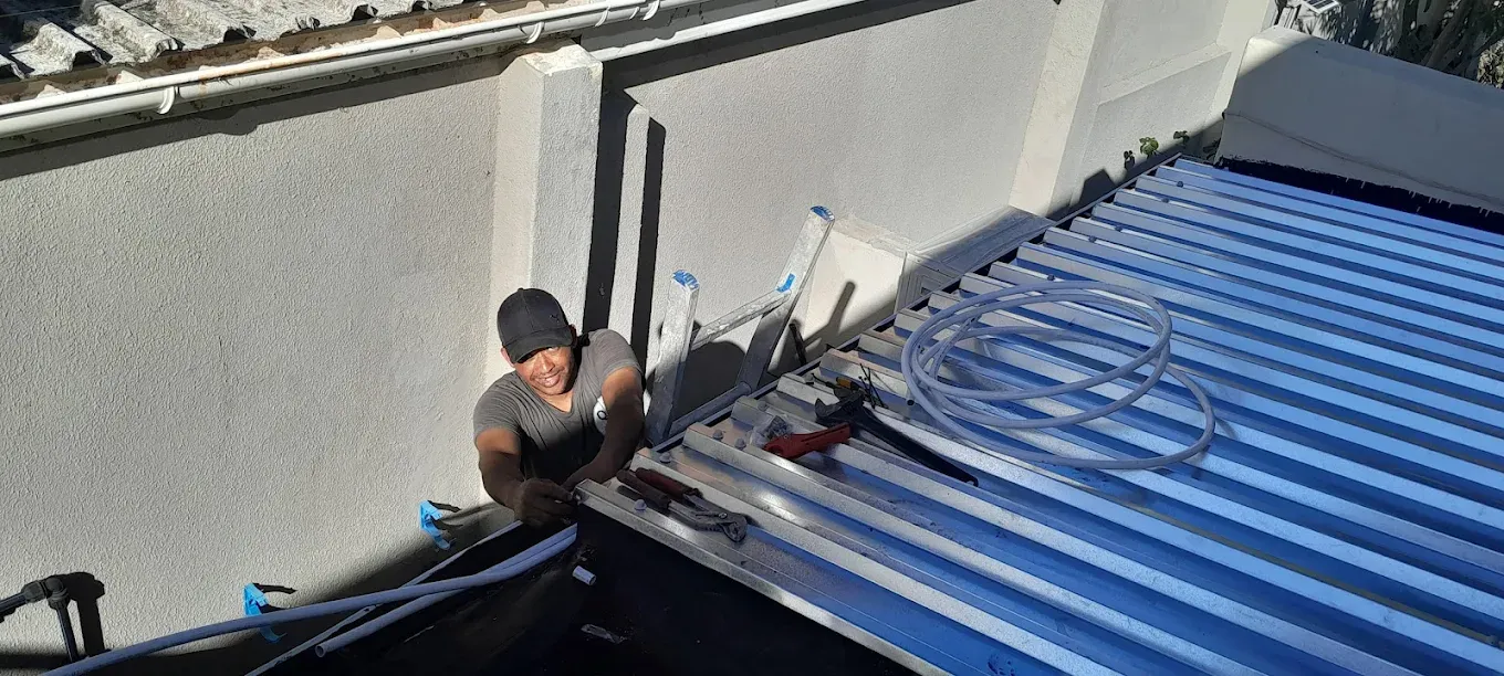 Abacas plumber repairing roof pipes in Western Cape