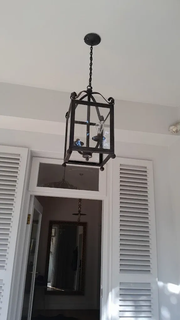 Wrought iron pendant light fitting installed in hallway